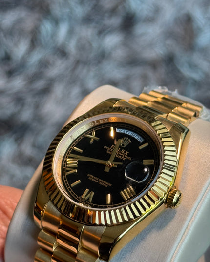 ROLEX DAY DATE II 41mm - BLACK ROMAN DIAL & BEZEM, YELLOW GOLD PRESIDENT BRAZALET